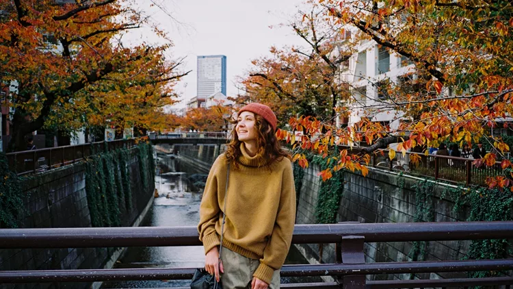 Woman walking in Tokyo, Japan in autumn