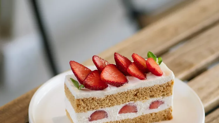 Fresh strawberry shortcake slice on a white plate
