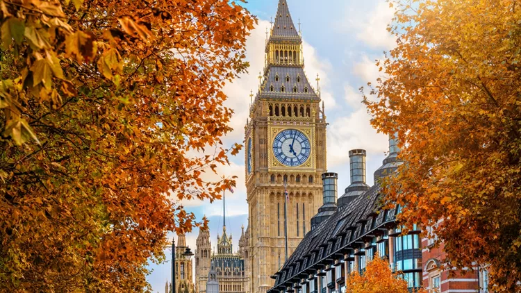 London during autumn time with the Big Ben clocktower and foliage
