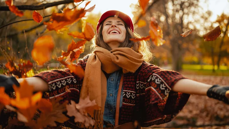 Happy elegant 40 years old woman with scarf rejoicing