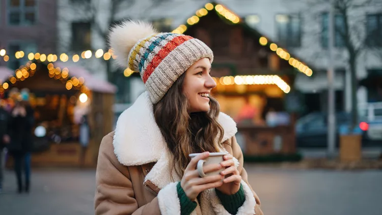 Happy smiling woman having fun at the Christmas market