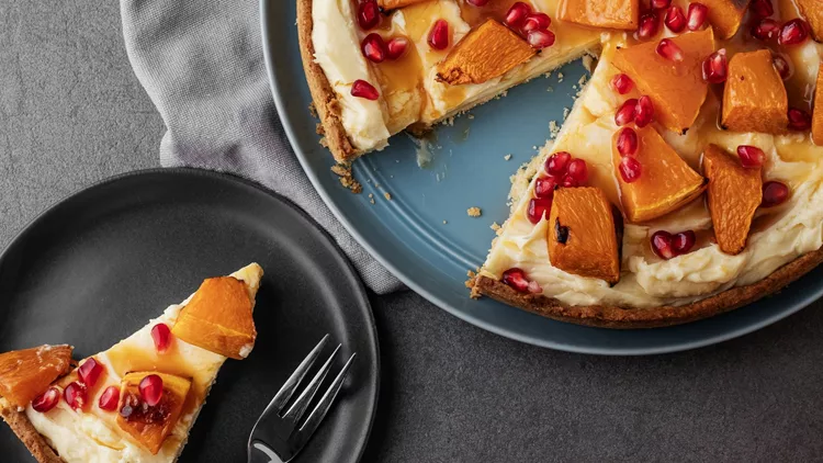 Pumpkin pie. Pumpkin and pomegranate cake with roasted butternut squash slice cross section. Tasty cheesecake. Tasty Christmas pie.