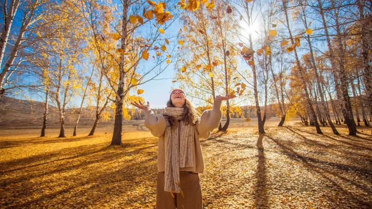 Young woman in the autumn weather in warm clothes and hats