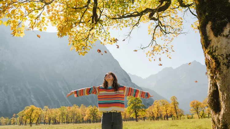 Woman enjoys autumn landscape in Alps