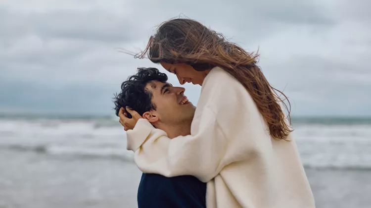 Romantic Couple Embracing on Beach, Sharing Tender Moment