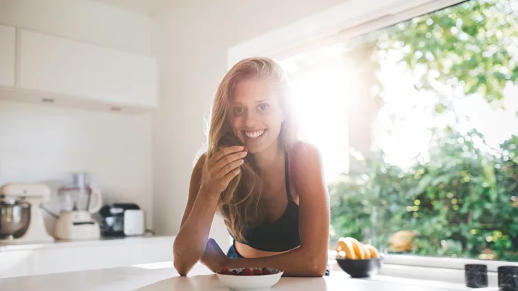 Young woman eating healthy breakfast