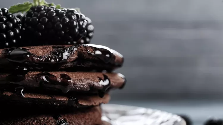 Tasty chocolate pancakes on plate, closeup
