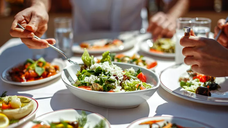 Couple  Eating Lunch with Fresh Salad and Appetizers