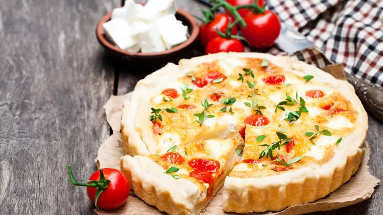 Cherry  tomatoes and cheese tart on wooden background