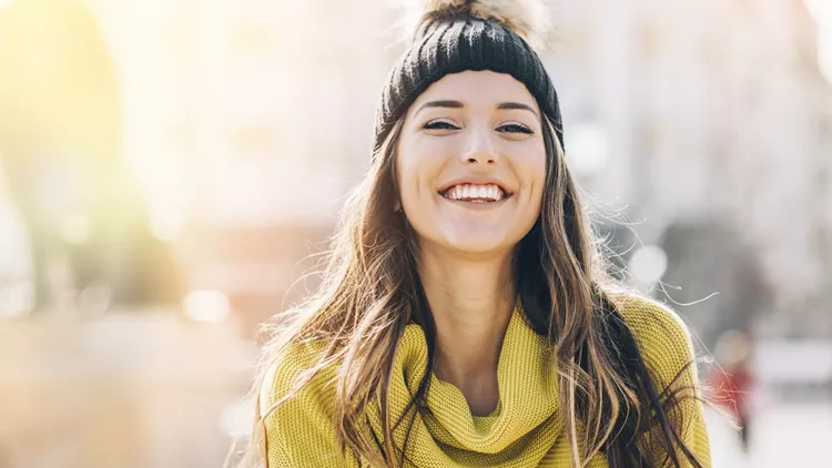 Smiling young woman at sunlight