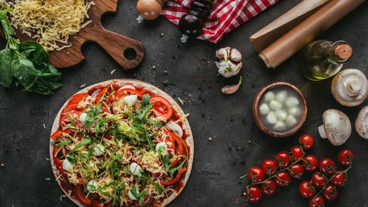 top-view-of-unprepared-pizza-with-ingredients-on-concrete-table-picture-id923075582