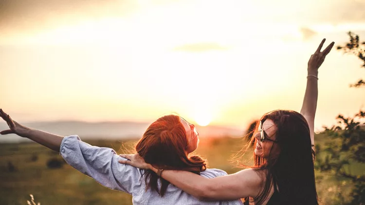 Teen girls look at the sunset