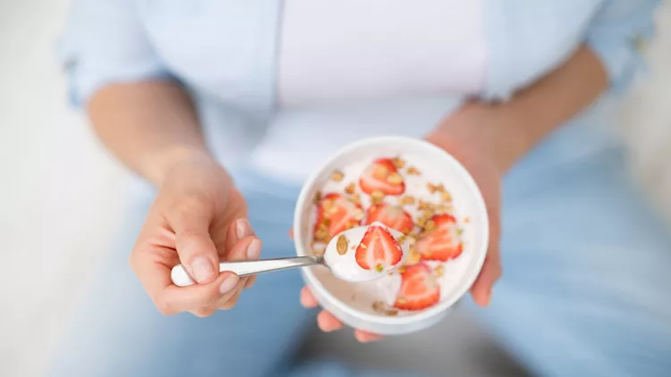 Woman eating a healthy bowl of cereals