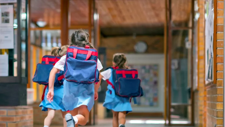 Excited students running towards entrance