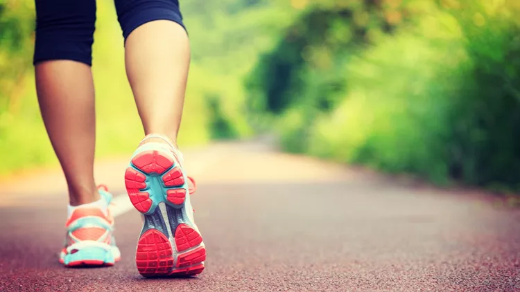 Young fitness female runner legs ready for run on forest trail