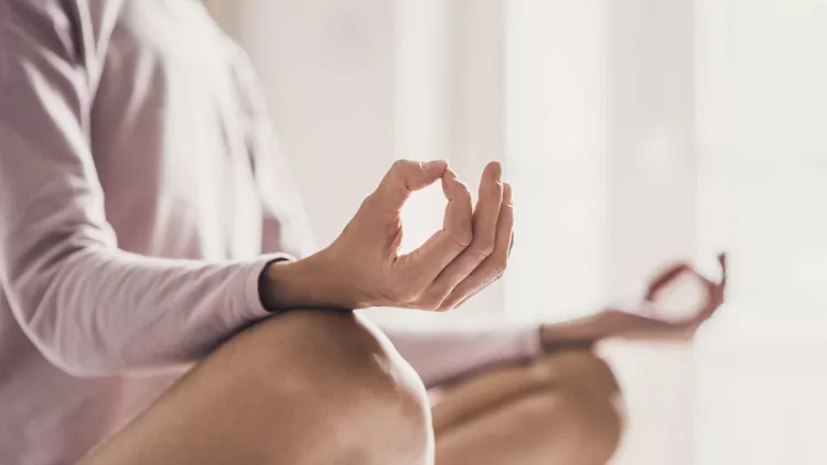 Woman meditating at home. Girl practicing yoga in yoga class