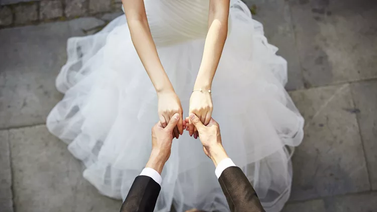 young asian adults dancing in wedding dress