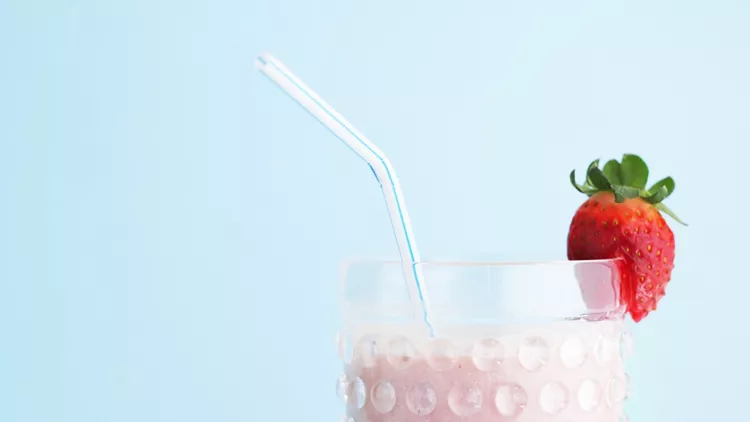 Strawberry smoothie on blue background
