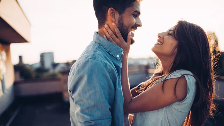 Beautiful couple in love dating outdoors and smiling