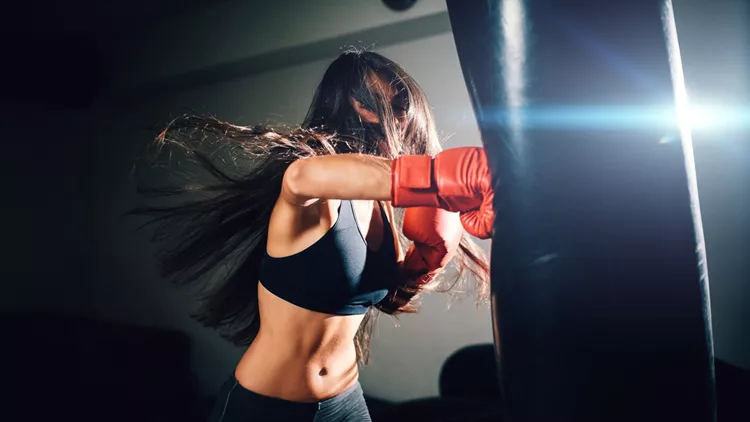 sexy fighter girl punching actively