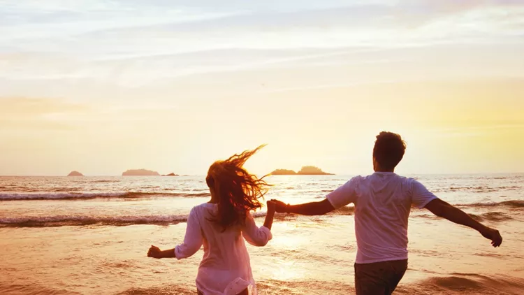 happy-couple-on-honeymoon-vacation-travel-beach-holidays-picture-id1047827366