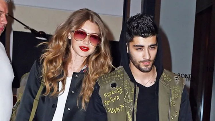 Matching Gigi Hadid and Zayn Malik hold hands as they head to the airport, NYC