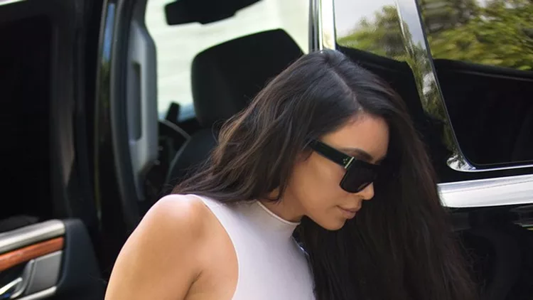 Kim Kardashian heads out in Miami wearing a see-through nude color top.