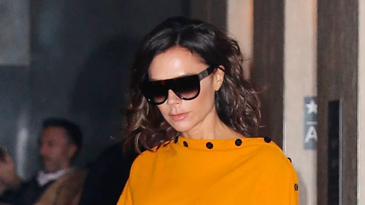 Victoria Beckham stuns in canary yellow paired with sky blue stilettos in New York