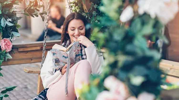 Enjoying a good book outdoors in the garden
