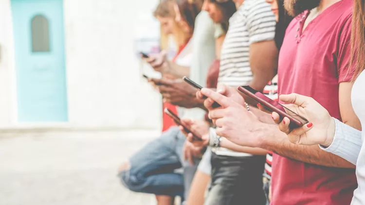 Group of friends watching smart mobile phones - Teenagers addiction to new technology trends - Concept of youth, tech, social and friendship - Focus on close-up phone