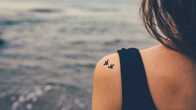 girl-with-birds-tattooed-on-shoulder-freedom-concept-picture-id496701212