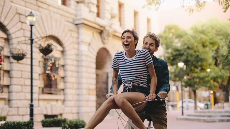 Couple enjoying a bicycle ride in the city