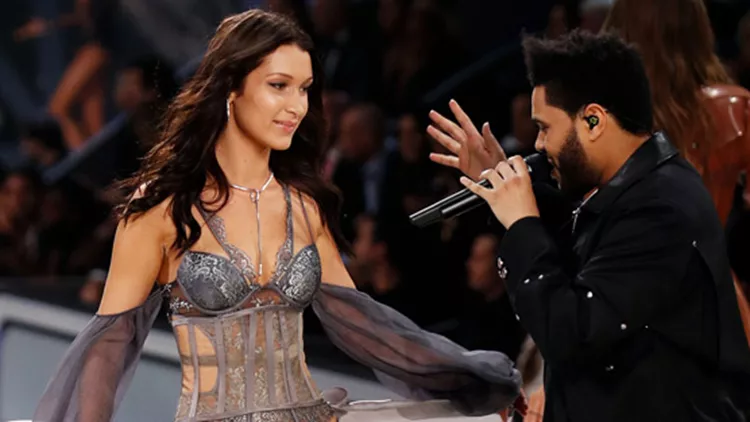The strange moment as Bella Hadid gets brushed off by her ex-bf The Weeknd when she tries to touch him as she's walking by him at the 2016 Victoria's Secret Fashion Show in Paris, France