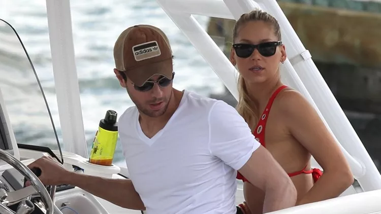 Enrique Iglesias and Anna Kournikova in a red bikini taking their weekend boat ride around Biscayne Bay in Miami