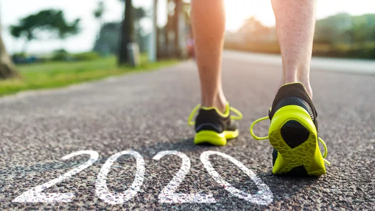 Man feet and number 2020 on the road