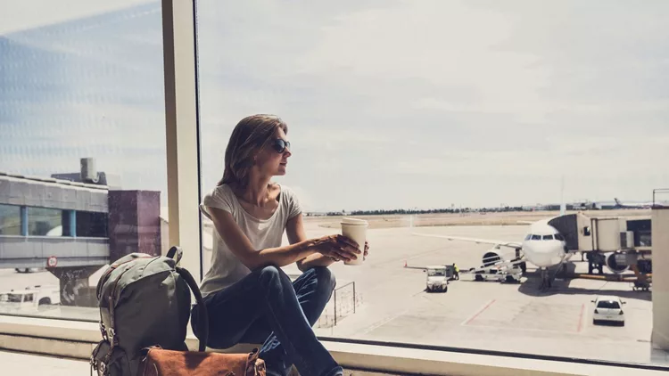 Young woman waiting for a plane. Travel concept