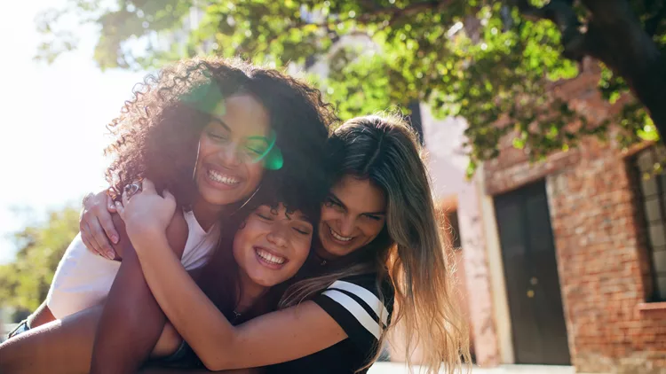 Group of female friends enjoying outdoors on city street