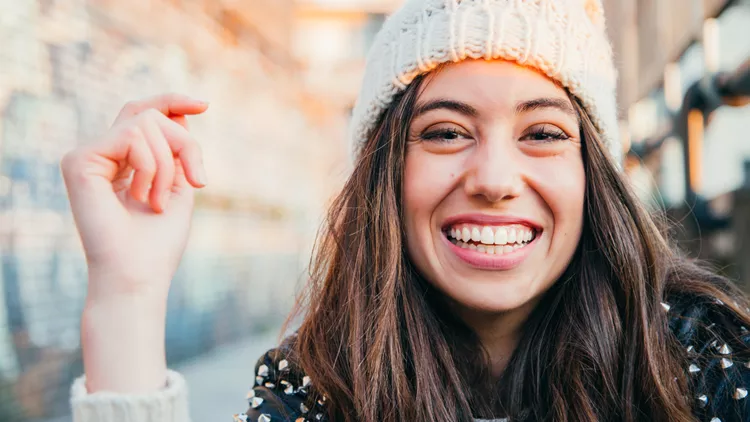 Laughing girl with woolen cap