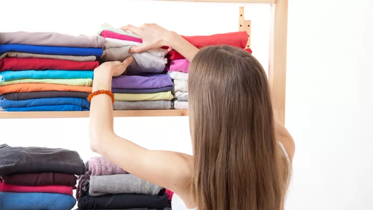 Young woman standing near the wardrobe