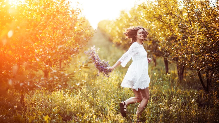 beautiful young woman with flower wreath in the garden