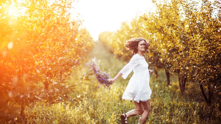 beautiful young woman with flower wreath in the garden