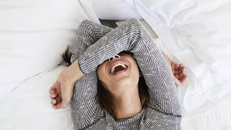 Laughing babe in bed