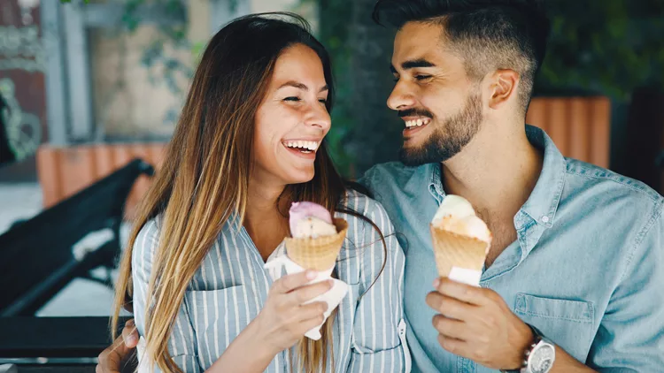 Happy couple having date and eating ice cream