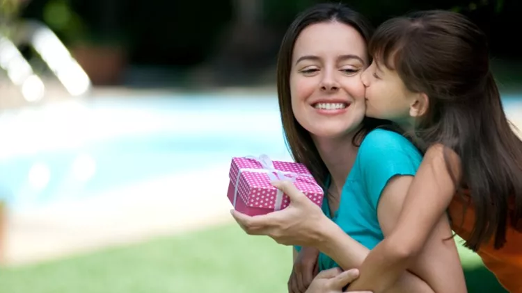 Mother receiving a gift from her daughter