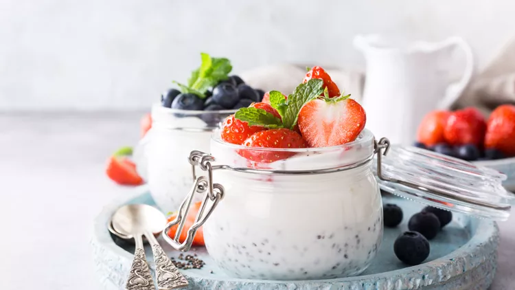Chia pudding with berries in glass jar.