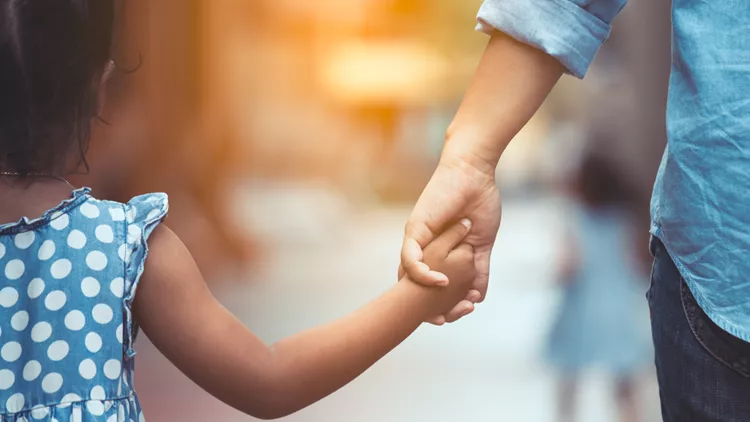 Mother and daughter holding hand together in vintage color tone