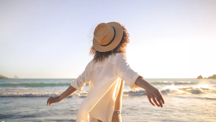 Young girl feeling good in front of the sea