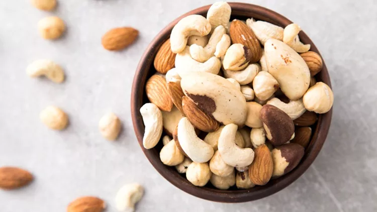 walnut-meats-assortment-of-nuts-cashews-almonds-hazelnuts-picture-id639812022
