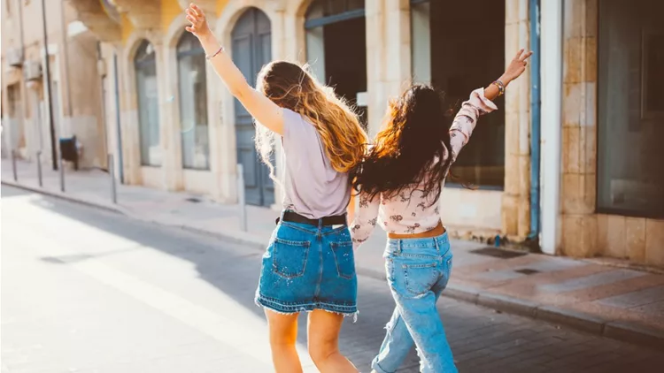 young-hipster-women-on-holidays-walking-cheerfully-in-old-streets-picture-id802496998