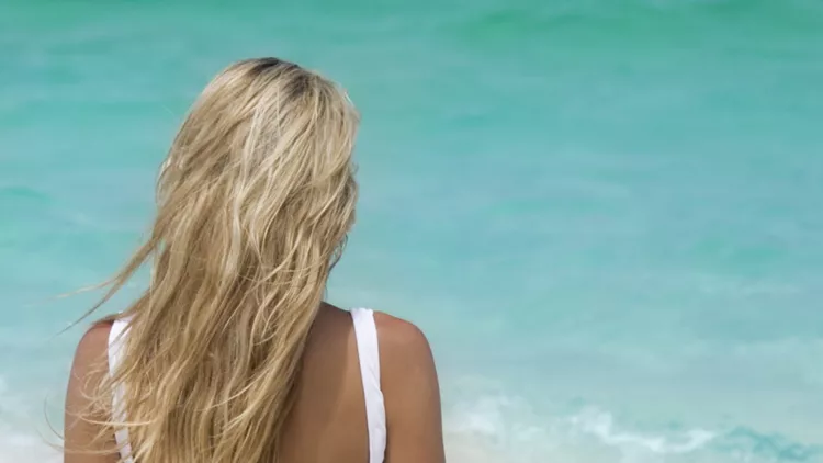 woman relaxing on tropical beach in the caribbean